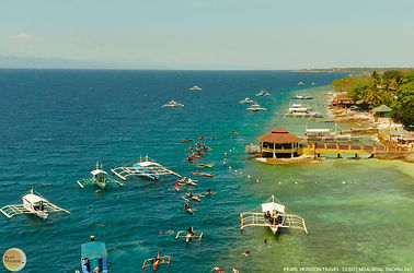 Observe outrigger boats and snorkelers exploring the coastal reefs. Add this lively ocean stop to your Moalboal marine and reef tour with Pearl Horizon Travel.