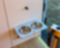 A custom made fold-out bowl holder on the partition wall in a custom build Ford Transit camper van by Redpoint Vanture.