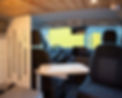 Lounge area with bench and swivel seat setup – convertible space for dining, relaxing, or remote work.