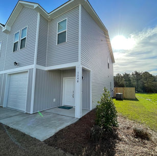 Side view of our newly built townhouse with fully fenced backyard for additional privacy during your stay!