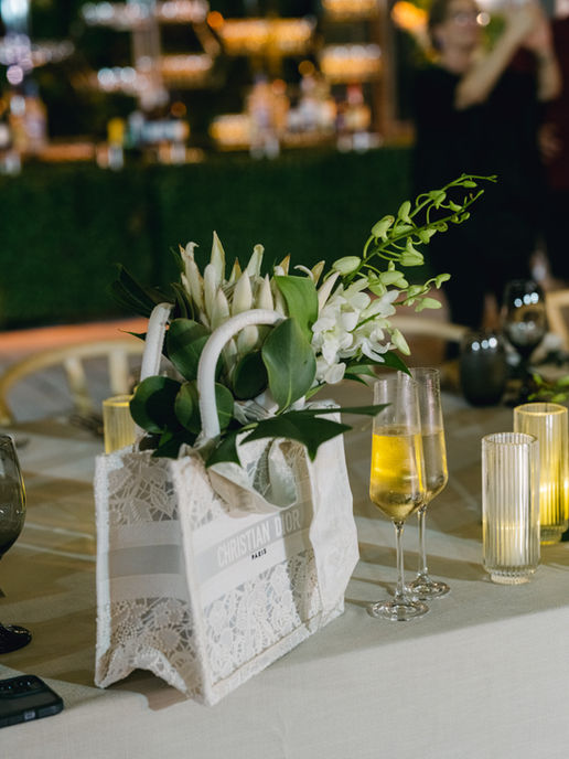 christian dior bag with wedding flowers on table at Melissa Davis Designs wedding