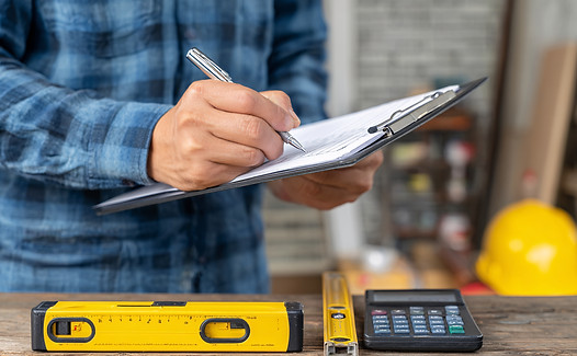 construction-worker-taking-notes-planning-project.jpg