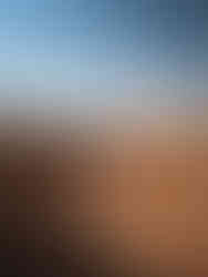 Layered red and white rock formations of the White Stupa cliffs in the Gobi Desert