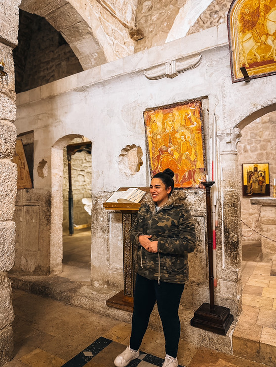 a local praying in a monastery and must-see places in Maaloula, Syria