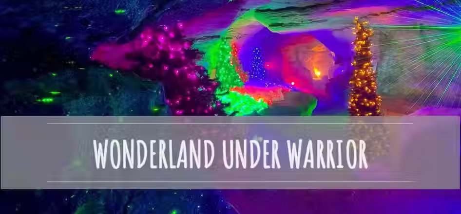 Colorful underground light display labeled “Wonderland Under Warrior” with glowing decorations inside a cave.