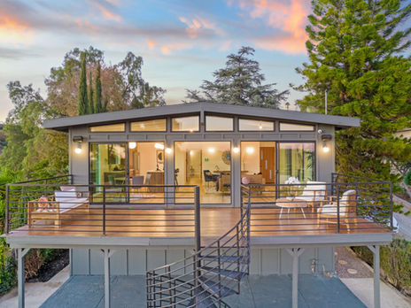 a house with a spiral staircase and a large deck