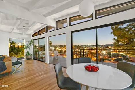 a dining room table with a bowl of apples on it