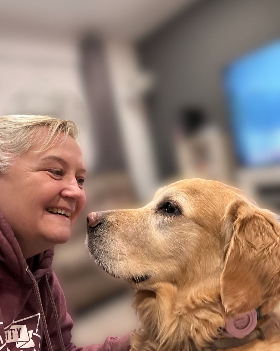 Tami, Founder of Pawsh Pet auPairs, meets a golden retriever at the meet and greet.
