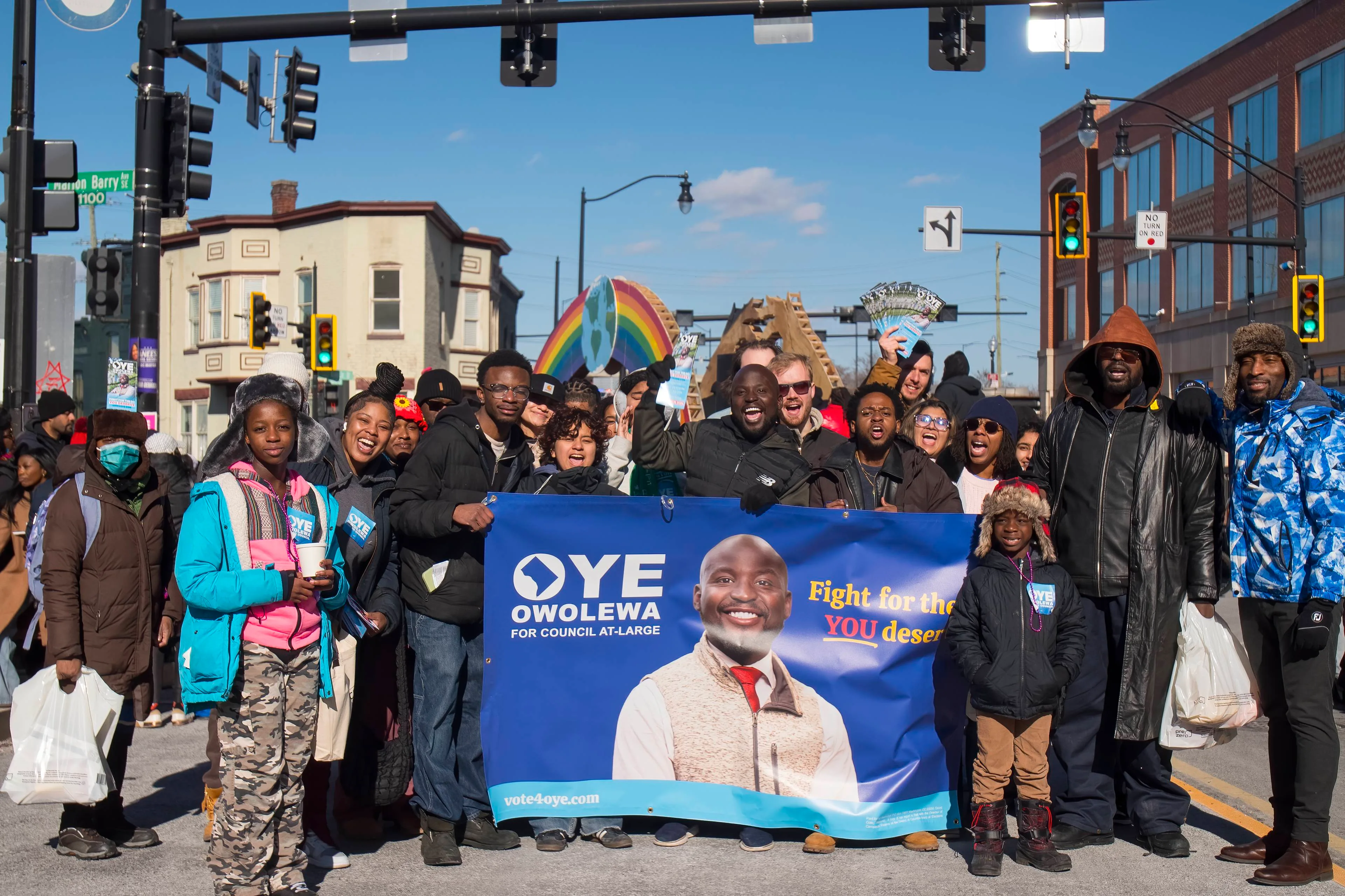 Campaign supporters gathered with a candidate banner during an outdoor political community event in Washington, DC.
