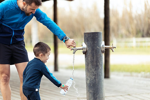 funny-little-boy-filling-his-water-bottle-in-publi-2021-08-28-20-06-52-utc copy 2.jpg