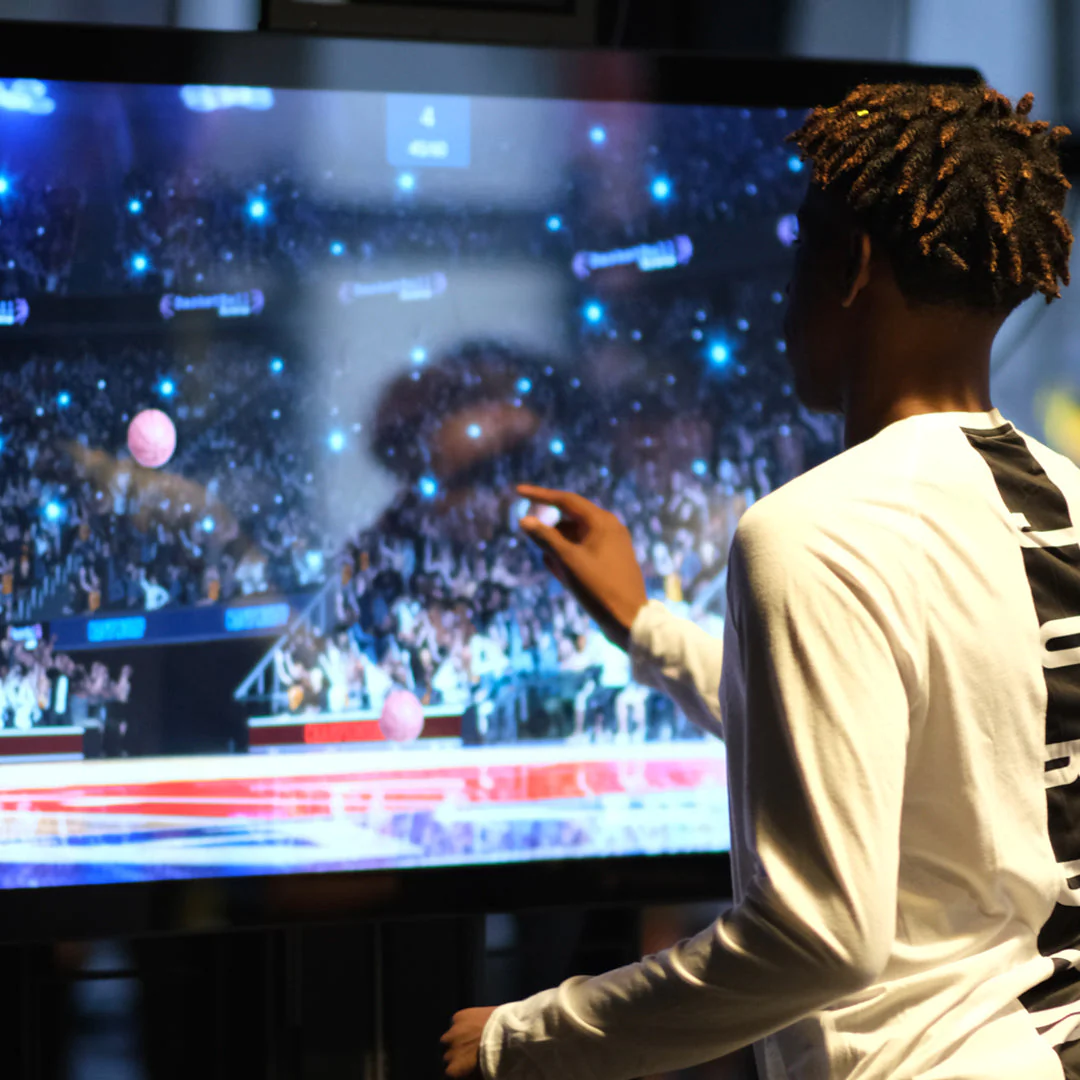 picture of an athlete using the Senaptec sensory station for training to improve athletic performance. The athlete is engaged in exercises that challenge hand-eye coordination and reaction time. This specialized training aids in enhancing sensory perception and motor skills, contributing to improved athletic performance and precision.