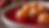Close-up view of golden brown gulab jamun balls soaking in rose syrup