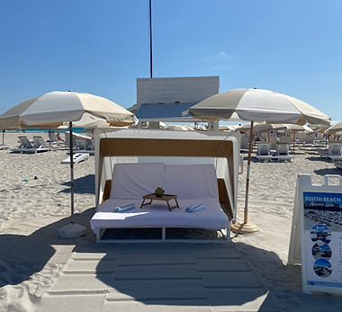 Friends celebrating with drinks at sunset on South Beach