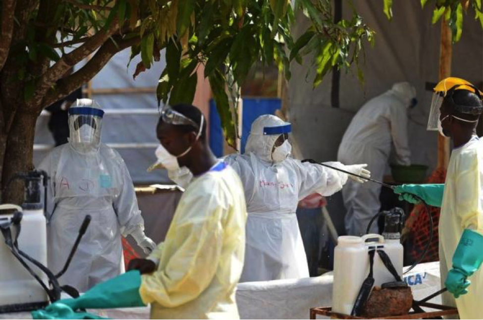 IMAGE DESCRIPTION: workers at a clinic in Sierra Leone are decontaminated after the hazardous work of treating Ebola patients. In some outbreaks where workers lacked adequate protective gear, health care provider death rates have approached 50%. IMAGE CREDIT: AFP.