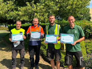 Grounds maintenance operatives holding certificates for IPM's GEM Awards
