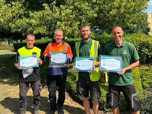 Grounds maintenance operatives holding certificates for IPM's GEM Awards