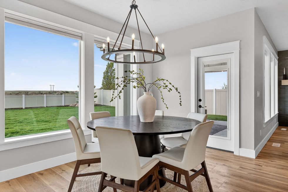Elegant dining room with round table and chandelier.