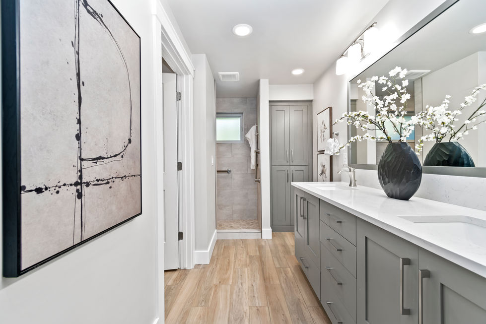 a bathroom with two sinks and a walk in shower
