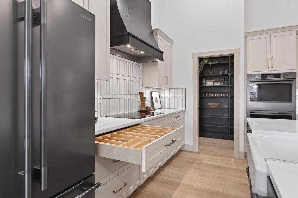 Modern kitchen with open drawers and sleek appliances.