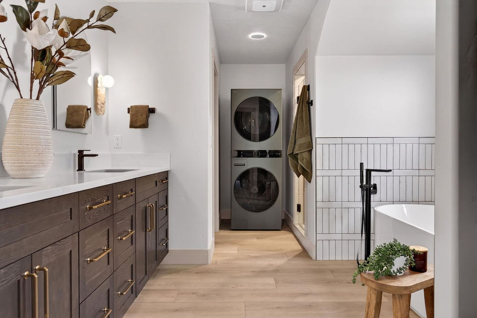 Modern bathroom with stacked washer and dryer.