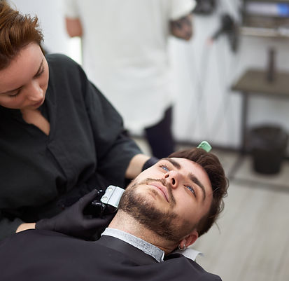 vecteezy_young-beautiful-caucasian-woman-hairdresser-cuts-beard_41554062.jpg