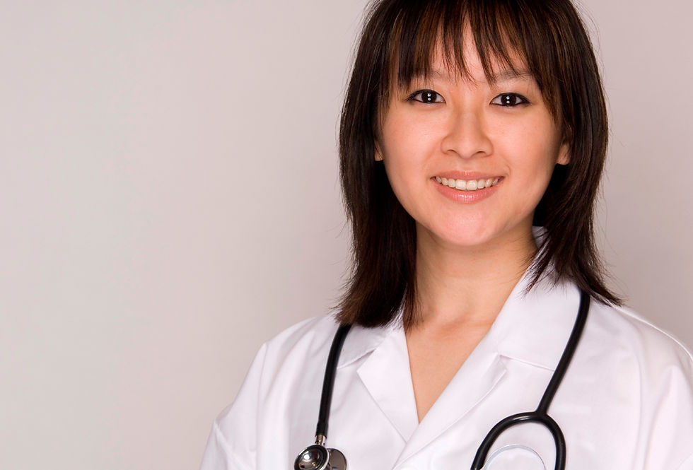 Smiling female physician with a stethoscope around her neck.