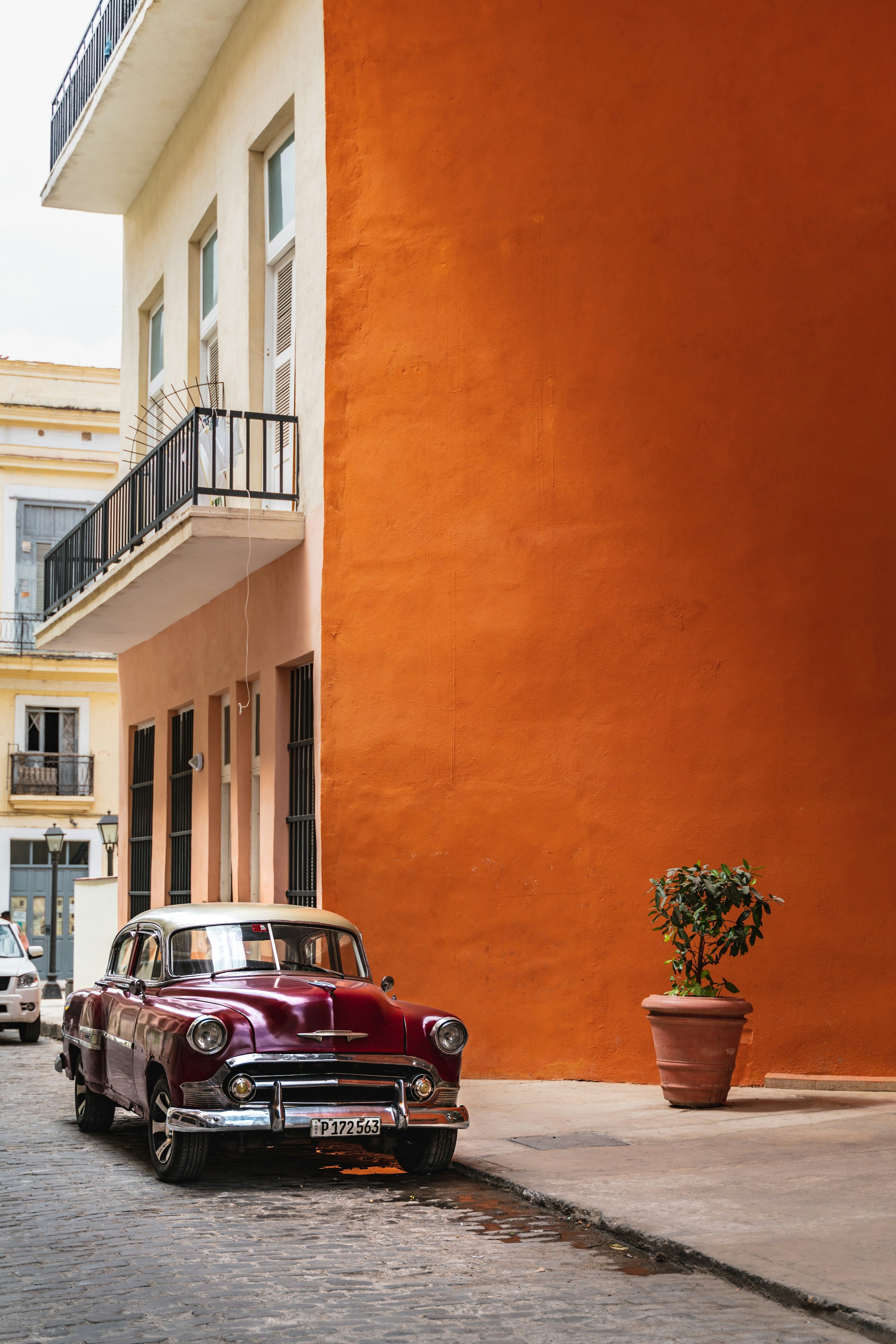 Colorful buildings along Havana street with vintage car