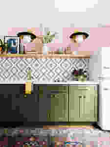 Green cabinets, pink walls, open shelving in guest house kitchen. Funky wall sconces, brass hardware and tap, fun tile back splash. Vintage style refrigerator. Vintage rug.