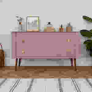 upcycled sideboard in dusty pink with brass hardware. Midcentury walnut legs. Styled with cacti, art, books and pots.