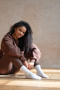 Brand photography mini session starting with a relaxed seated portrait, showing how clients are gently guided into natural poses.