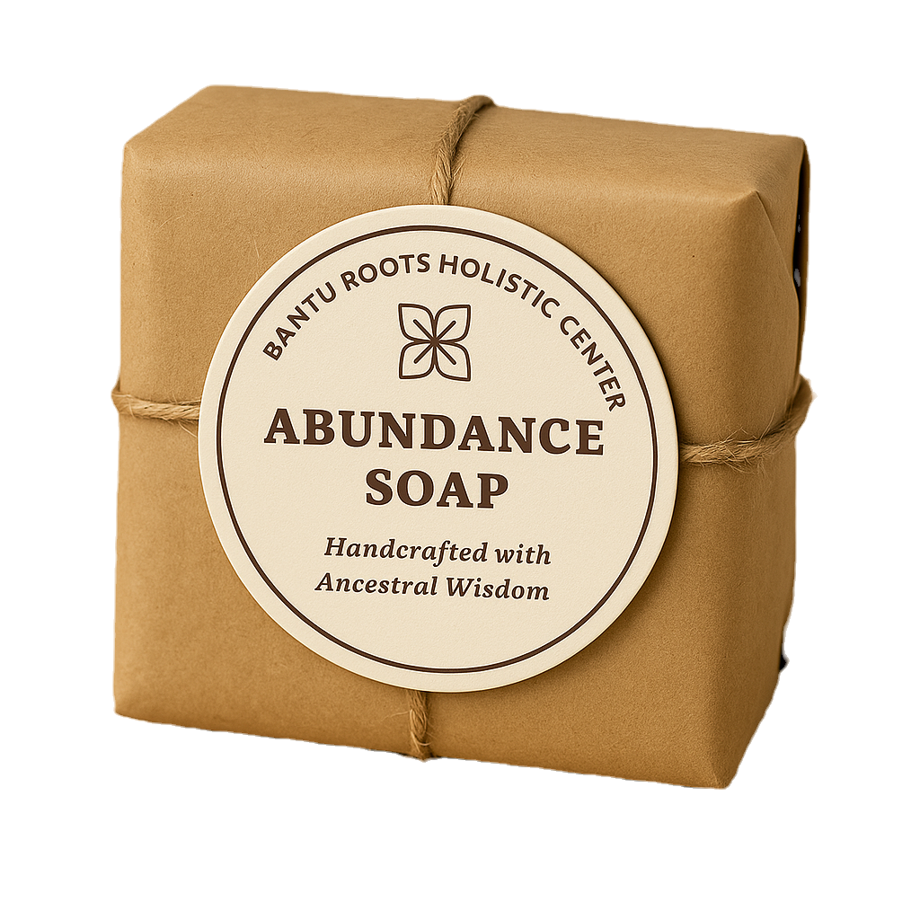A close-up shot of the "Abundance Soap" wrapped in brown paper with a round, off-white label. The label features a floral log