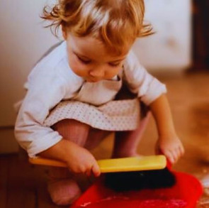 Image of a young child helping with their own chores.