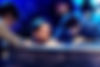 Tattooed man in a baptismal tub closes his eyes & is prayed over by a man & woman at tub’s side & the congregation (not pictured) before being baptized.