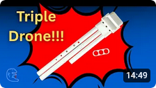 Focus on hands carefully tuning a PVC drone flute attachment.