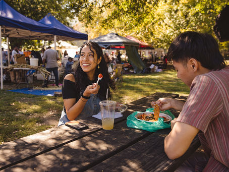 Two people sitting in FDR Park in South Philly eating food at a picnic bench