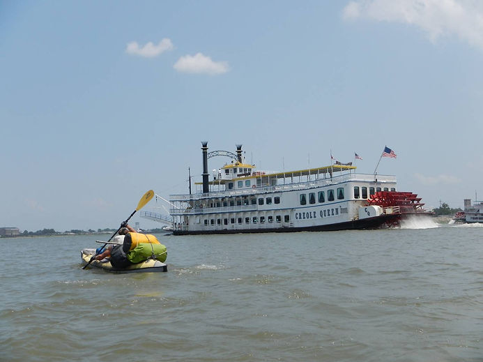 Jim "The Shark" Dreyer paddling beside the Creole Queen in New Orleans.