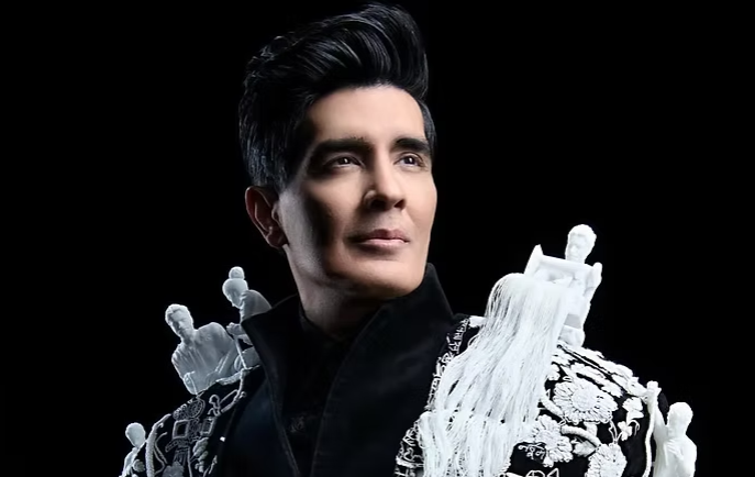 Manish Malhotra at Met Gala 2026 wearing custom black bandhgala and embroidered velvet cape with 3D artisan figurines