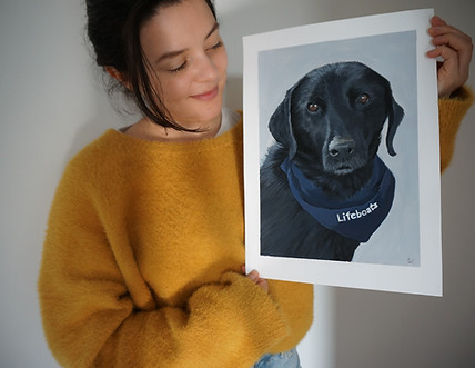 Photograph of Tess with her custom painting of meg the labrador.