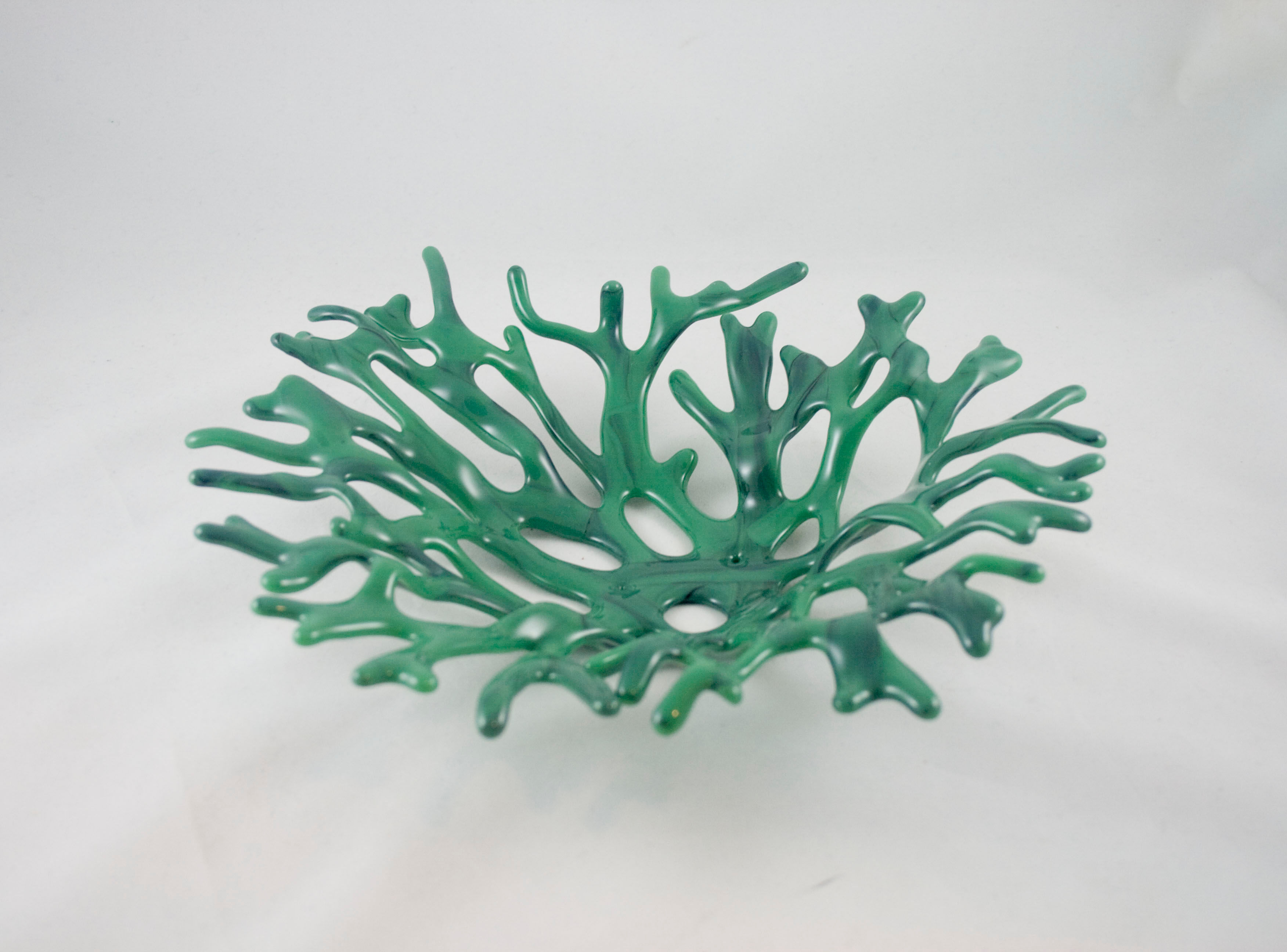 Green coral bowl sculpture with streaks of black