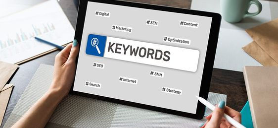 holding tablet with keywords all over