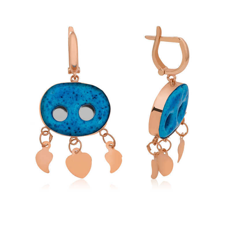 Silver Assyrian Eye Earring The evil eye bead of the Assyrian eye earring is entirely handcrafted and made by Assyrian masters. It is made of 925 carat silver. The stone is Iranian turquoise. The two holes on the stone represent two eyes. This product, which has a different design, is rare and elegant and is among the most admired