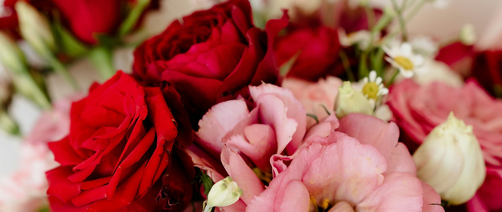 Pink and red floral arrangement featuring romantic blooms in a modern style
