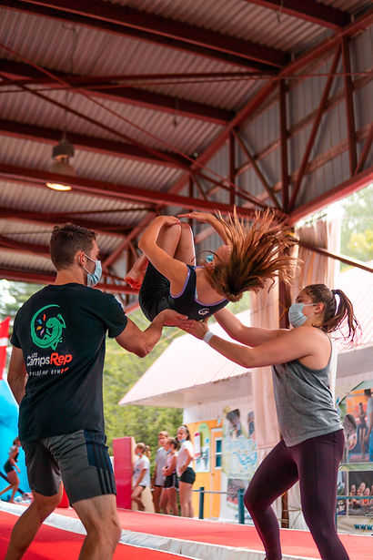 two coaches and a gymnast at GymRep summer camp