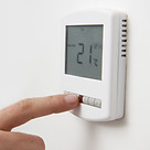 Air conditioner thermostat being adjusted