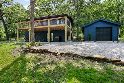 Modern two-story house with blue siding and a detached garage on property