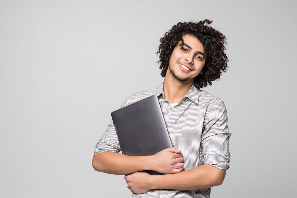 handsome-young-curly-haired-man-working-laptop-computer-standing-isolated-white-wall.jpg