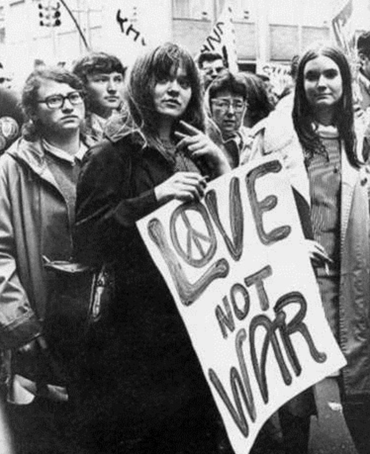 Fig 2. Caroline Kastle holding a sign in the 1967 Philadelphia Love In protest.