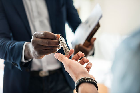 real-estate-agent-handing-house-key-client.jpg