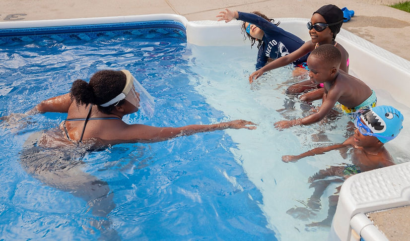 Paulana Lamonier teach young African American children how to swim