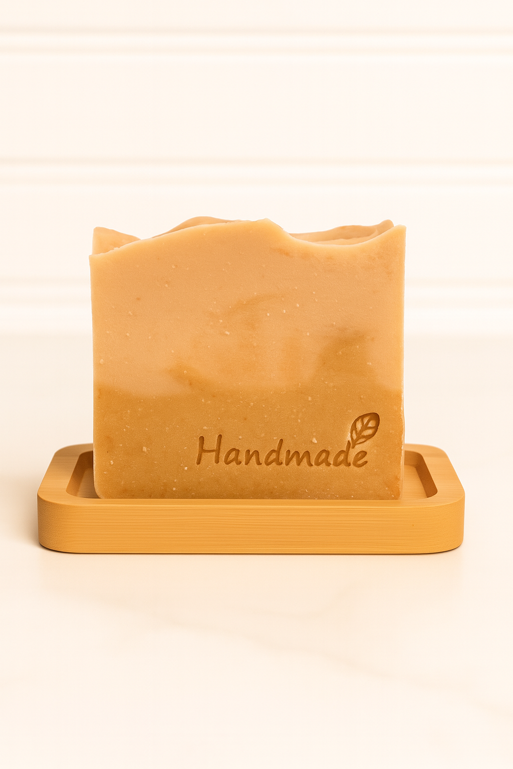 ReLuminate goat’s milk soap bar with handmade stamp on a bamboo soap dish, bright refreshing scent and creamy texture.